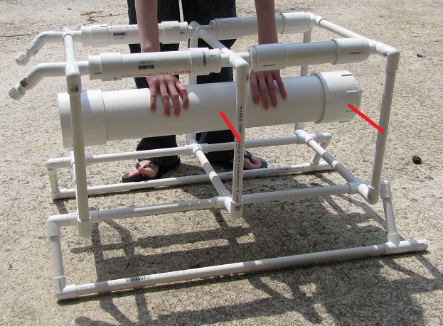 Me holding the 4" hull roughly where it will be mounted, the red lines are there to show how I was planning to attach the hull to the side pieces.